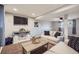 Finished basement featuring plush carpeting, a television and comfortable sofas at 6592 S Cody Way, Littleton, CO 80123