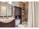 Cozy bathroom featuring a shower over tub, a pedestal sink and a medicine cabinet at 6592 S Cody Way, Littleton, CO 80123