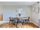 Dining room with wood floors, a rustic table, and ample natural light creates a welcoming atmosphere at 6592 S Cody Way, Littleton, CO 80123