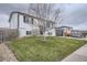 Charming two-story home with a well-manicured lawn and attached garage under a cloudy sky at 6592 S Cody Way, Littleton, CO 80123