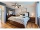 Charming main bedroom featuring hardwood floors, ceiling fan, and abundant natural light at 6592 S Cody Way, Littleton, CO 80123