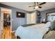 Comfortable main bedroom with walk-in closet, hardwood floors and ceiling fan at 6592 S Cody Way, Littleton, CO 80123