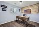 Office boasts a rustic wood accent wall with an American flag and features a large window and wood desk at 6592 S Cody Way, Littleton, CO 80123