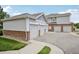 Attached garages featuring white garage doors and brick base on the exterior of townhomes at 10129 W 55Th Dr # 3, Arvada, CO 80002