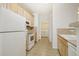 Well-lit kitchen with white appliances, ample cabinets, and tiled backsplash at 10129 W 55Th Dr # 3, Arvada, CO 80002