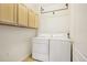 Convenient laundry room equipped with a washer, dryer, and storage cabinets at 10129 W 55Th Dr # 3, Arvada, CO 80002