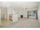 Inviting living room with fireplace, large window, and access to the kitchen at 10129 W 55Th Dr # 3, Arvada, CO 80002