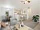Bright open-concept living room with dining area, kitchen bar, and neutral décor at 10129 W 55Th Dr # 3, Arvada, CO 80002