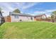 Expansive backyard featuring a well-maintained lawn and a charming patio area, perfect for outdoor entertaining at 4182 S Joplin St, Aurora, CO 80013