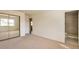 Spacious bedroom featuring plush carpeting, a mirrored closet, and an attached bathroom with a tiled shower at 4182 S Joplin St, Aurora, CO 80013
