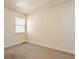 Bright bedroom featuring a large window providing natural light and neutral carpet at 4182 S Joplin St, Aurora, CO 80013