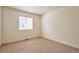 This bright bedroom offers natural light from the window and neutral carpet at 4182 S Joplin St, Aurora, CO 80013