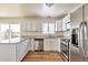 Modern kitchen featuring stainless steel appliances, granite countertops, and sleek white cabinetry at 4182 S Joplin St, Aurora, CO 80013