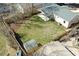 Aerial view of a backyard with lush lawn, wood fence, shed, and covered patio at 1430 S Glencoe St, Denver, CO 80222