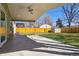 Covered patio overlooks large fenced yard with lawn and a storage shed at 1430 S Glencoe St, Denver, CO 80222