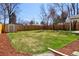 Large backyard with healthy lawn, wood fence and storage shed in view at 1430 S Glencoe St, Denver, CO 80222