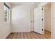 Empty bedroom showcasing hardwood floors and a bright window at 1430 S Glencoe St, Denver, CO 80222