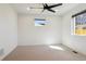 Empty bedroom featuring neutral carpet, trim, and paint, and a bright window at 1430 S Glencoe St, Denver, CO 80222