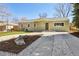 Charming home with manicured lawn, stone accents, and a welcoming front porch at 1430 S Glencoe St, Denver, CO 80222