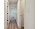 Hallway with hardwood floors and white trim throughout and access to other rooms at 1430 S Glencoe St, Denver, CO 80222