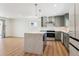 Bright kitchen featuring a center island, modern appliances, and open layout into the living area at 1430 S Glencoe St, Denver, CO 80222