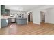 Bright, open kitchen featuring modern appliances, a center island, and seamless flow to the living area at 1430 S Glencoe St, Denver, CO 80222
