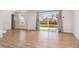 Bright living room featuring sleek flooring, natural light, and sliding glass door leading to the yard at 1430 S Glencoe St, Denver, CO 80222