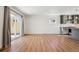 Bright living room featuring hardwood floors, recessed lighting, and an open layout to the modern kitchen at 1430 S Glencoe St, Denver, CO 80222