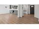 Open living area with kitchen view featuring an island with gray cabinets and stainless appliances at 1430 S Glencoe St, Denver, CO 80222