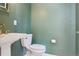 Stylish half bath with a pedestal sink, sleek fixtures and updated tiling at 1430 S Glencoe St, Denver, CO 80222