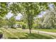 Green backyard with a view of lush greenery, trees and a pond at 1540 W Briarwood Ave, Littleton, CO 80120