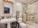Classic bathroom featuring a pedestal sink, tiled shower, and neutral color palette at 1540 W Briarwood Ave, Littleton, CO 80120