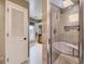 Bathroom with tiled shower and tub, with additional vanity area and window at 1540 W Briarwood Ave, Littleton, CO 80120