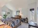 Bright bedroom featuring vaulted ceilings, a large window, and wooden furnishings at 1540 W Briarwood Ave, Littleton, CO 80120