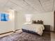 Basement bedroom featuring a plush rug, comfortable bed, and natural light at 1540 W Briarwood Ave, Littleton, CO 80120
