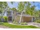 Charming home exterior with stone accents, a manicured lawn, and lush landscaping at 1540 W Briarwood Ave, Littleton, CO 80120