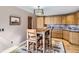Breakfast nook features an eat-in kitchen area with knotty pine cabinets and neutral countertops at 1540 W Briarwood Ave, Littleton, CO 80120