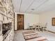 Stone accent wall and bright living room area with comfortable seating at 1540 W Briarwood Ave, Littleton, CO 80120