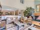 Spacious living room featuring stone accents, a fireplace, and an open floor plan at 1540 W Briarwood Ave, Littleton, CO 80120