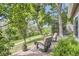 Outdoor patio seating with a scenic view of lush greenery and walking path at 1540 W Briarwood Ave, Littleton, CO 80120