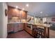Basement wet bar features beautiful wood cabinets, granite countertops, and seating for guests at 1030 Timbercrest Dr, Castle Pines, CO 80108