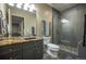 Bathroom boasts modern vanity, mirror, and glass-enclosed shower with pebble floor at 1030 Timbercrest Dr, Castle Pines, CO 80108