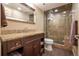 Bathroom features a granite countertop, wood cabinets, and a glass-enclosed shower at 1030 Timbercrest Dr, Castle Pines, CO 80108