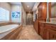 Bathroom with soaking tub, glass enclosed shower, tile flooring, and beautiful custom cabinets at 1030 Timbercrest Dr, Castle Pines, CO 80108