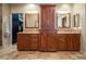 Bathroom with dual sink vanity, granite countertops, and custom-built storage cabinets at 1030 Timbercrest Dr, Castle Pines, CO 80108