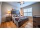 Bedroom featuring hardwood floors, a ceiling fan, and a decorative wood frame bed at 1030 Timbercrest Dr, Castle Pines, CO 80108