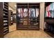 Walk-in closet with custom shelving and mirrored doors maximizing organization and storage space at 1030 Timbercrest Dr, Castle Pines, CO 80108