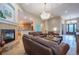 Spacious living room featuring a fireplace and open access to the kitchen at 1030 Timbercrest Dr, Castle Pines, CO 80108