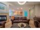 Cozy living room with stone fireplace and open-concept to the updated kitchen at 1030 Timbercrest Dr, Castle Pines, CO 80108