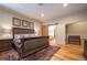 Elegant main bedroom featuring a decorative rug, wood floors, and barn door to bathroom at 1030 Timbercrest Dr, Castle Pines, CO 80108